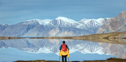 Arctic mountainscape with expedition traveller.